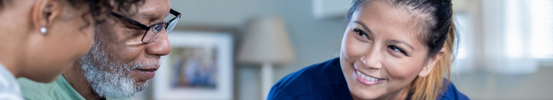 Nurse with adult patients smiling