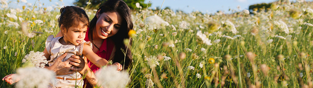 "mother and daughter in field of flowers"